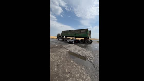 Driver performs stunt by passing under moving truck in Rostov-on-Don, Russia