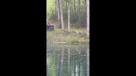 Father helps child lift big fish in Athens, Tennessee, USA