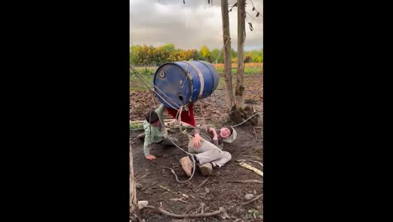 Two people fall off shaking drum tied between trees in Santiago, Chile