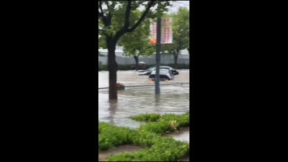 Severe flooding submerges vehicles on street in Suzhou, China