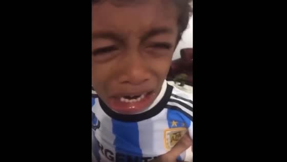 Child reacts emotionally after Argentina’s loss to Saudi Arabia in Ternate, Indonesia