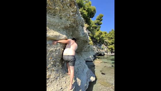 Man slips while climbing seaside rocks in Thessaloniki, Greece