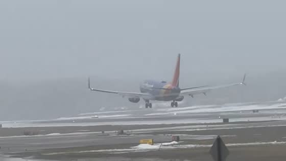 Plane lands through heavy fog at airport in Rochester, New York, USA