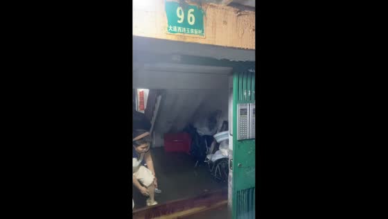 Floodwater pours through building ceiling in Shanghai, China