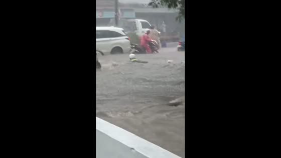 Motorist swept away by floodwaters on highway in Malang, Indonesia