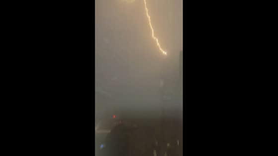 Lightning illuminates high-rise buildings during torrential rain in Suzhou, China