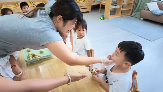 Little boy takes a bite of raw mooncake dough in Zhejiang, China