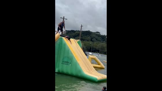 Excited rider slips before inflatable water slide in Campo Largo, Paraná, Brazil