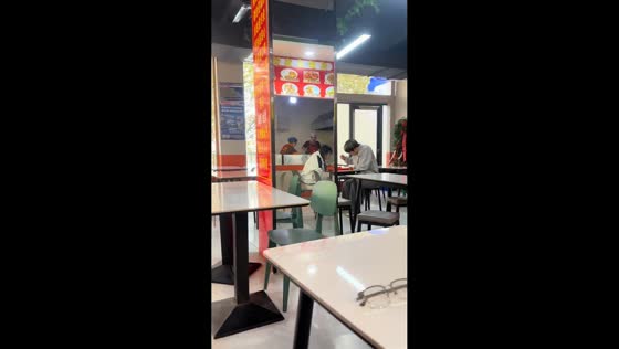 Restaurant reflection creates illusion of man dining with woman in Gansu, China