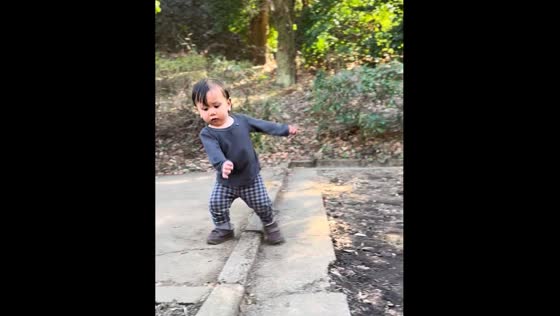 Child nearly falls while walking on uneven ground in Tokyo