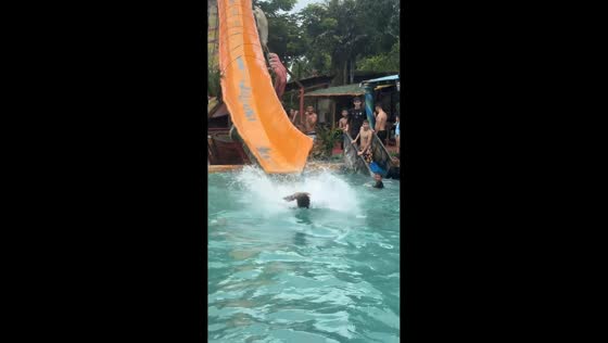 Elderly woman takes a funny plunge down a slide in Ocumare, Venezuela