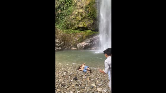 Person falls at Budar waterfall in Nepal