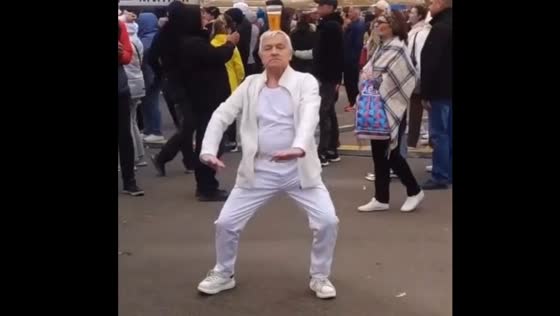 Charismatic man dancing with a glass of beer on his head in Minsk, Belarus