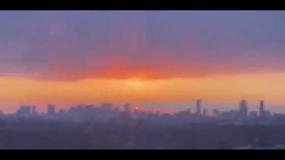 Vibrant sunrise paints sky over Fresh Pond in Cambridge, Massachusetts, USA