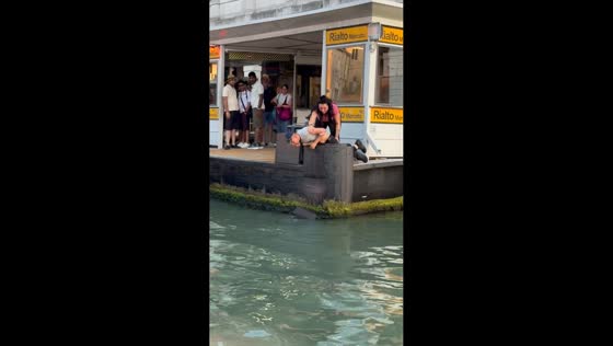 Man retrieves luggage from Grand Canal in Venice, Italy