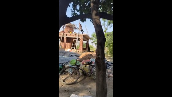 Man laughs off fall after failed pole descent at construction site in Farrukhabad, India