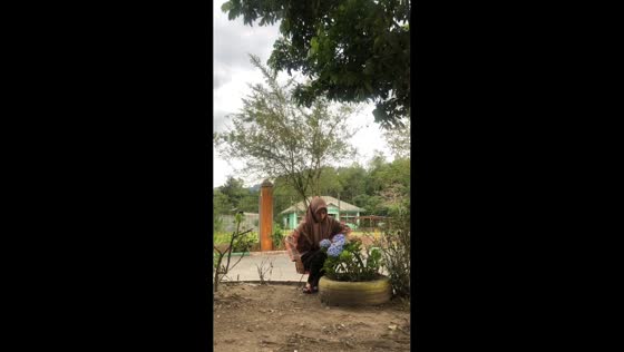 Woman pricked by plant stem while inspecting flower in Aceh, Indonesia