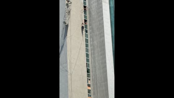 Firefighters rescue two workers trapped on tilted suspended platform in Xuchang, China