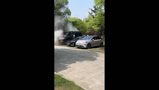 Van catches fire in parking lot in Jiangsu, China