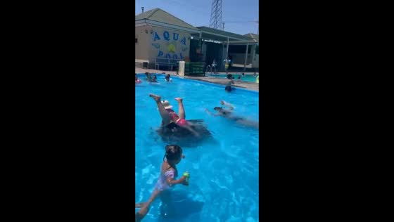 Woman loses balance while lifting child in pool in Uzynagash, Kazakhstan