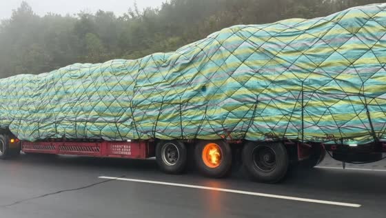 Freight truck travels along a highway with a burning wheel in Hong Kong, China