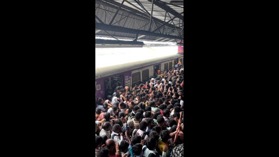 Heavy commuter rush overwhelms platform at railway station in Thane, Mumbai, India