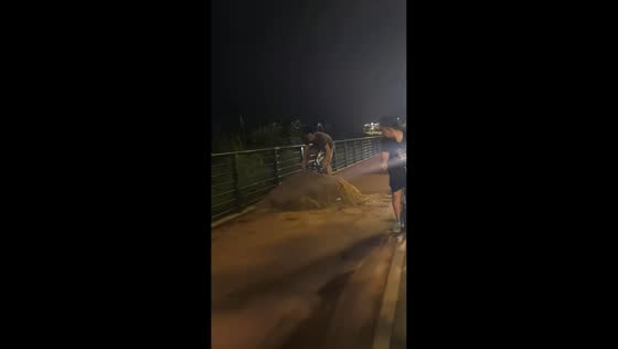 Cyclist takes tumble after hitting dirt ramp during night ride in Anhui, China