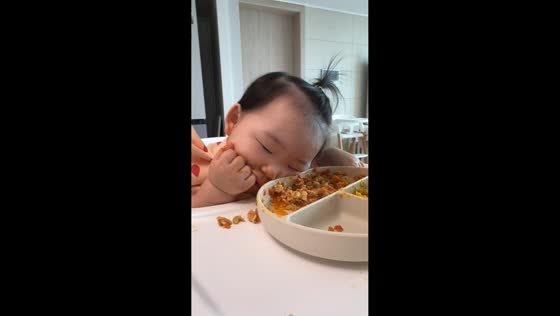Sleepy baby dozes off while eating in Seoul, South Korea