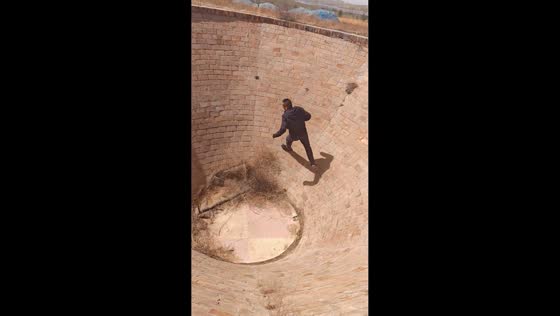 Man performs wall-running climb inside brick pit in Shaanxi, China