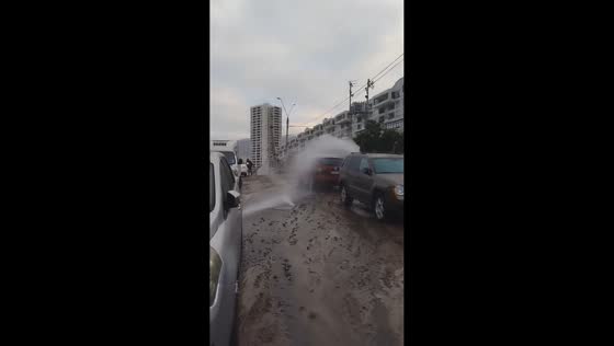Burst water main sends water surging across street in Iquique, Chile