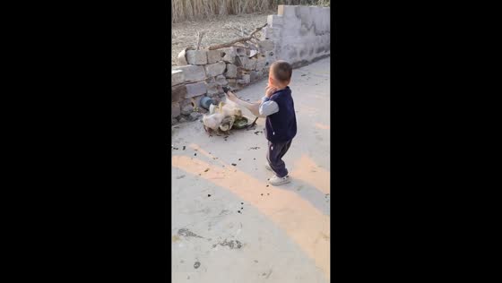 Goose playfully tugs at boy’s clothing in Guangxi, China