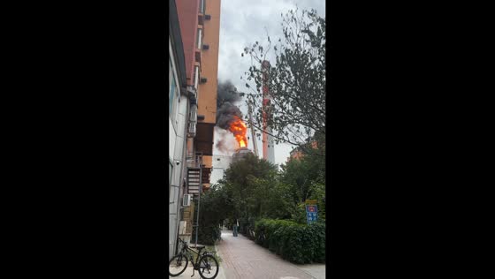 Massive flames engulf upper section of building in Jilin, China