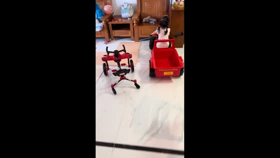 Young girl crashes toy tractor into cabinet in Guangdong, China