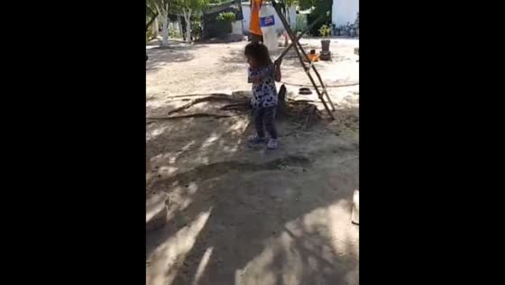 Playful attempt to hit a hanging bottle in Caracol, Guasave, Mexico