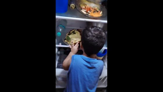 Boy caught sneaking pizza from fridge in Paysandú, Uruguay