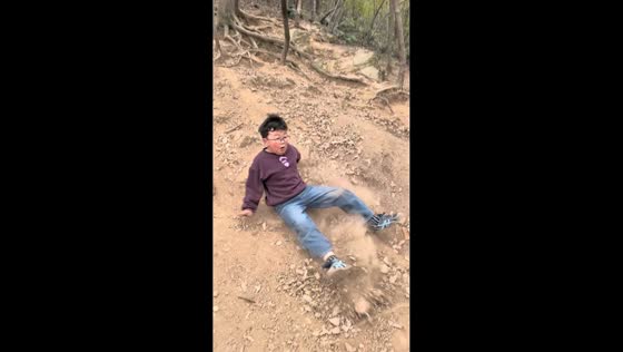 Boy slips and falls while walking downhill in Jiangsu, China