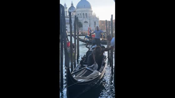 Women scream while leaving gondola during Venice tour, Italy