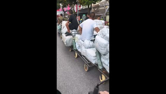 Motorcycle rider crashes after being distracted by cart "train" in Guangdong, China