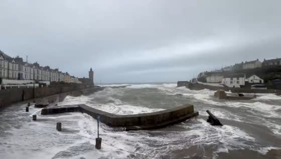 Rough seas and crashing waves hit Porthleven harbour, in Cornwall, England, UK