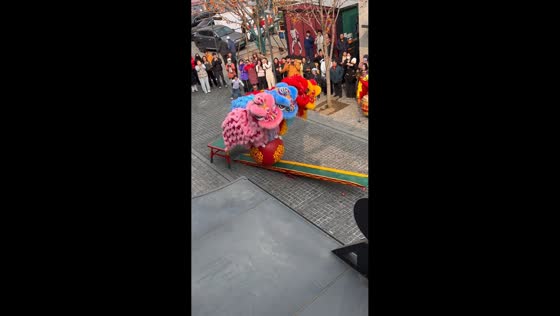 Four performers balance atop giant ball during lion dance in Beijing, China