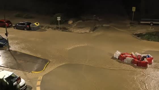Flash floods sweep away road barriers and inundate vehicles in Oliva, Spain