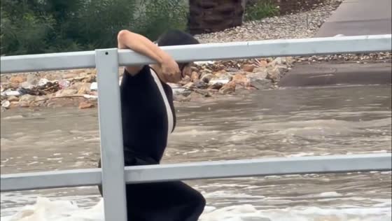 Woman slips in floodwaters before turning back near Flamingo Las Vegas, USA