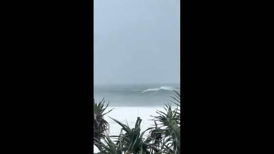 Surfer braves massive waves despite Cyclone Alfred warnings in Burleigh Heads, Australia
