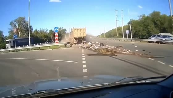 Truck collision pushes car into barrier on Nezhinskoye Highway in Orenburg, Russia