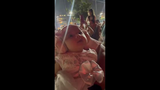 Baby mesmerized by fireworks in Vitória, Espírito Santo, Brazil