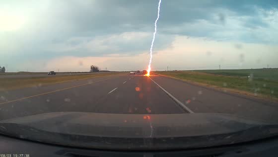 Lightning bolt strikes road close to vehicles in dash cam video from Calgary, Alberta