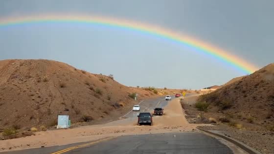 Flooded road and rainbow spotted after rainfall in Bullhead, Arizona, USA