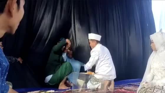 Oops! Witness falls backwards during wedding seating!