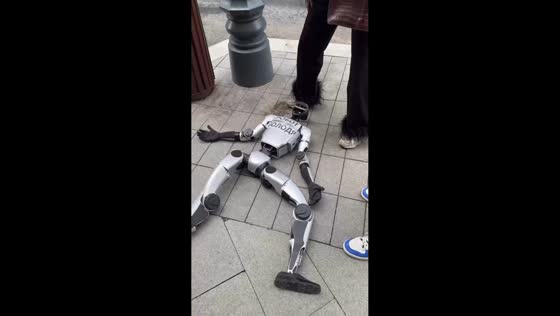 Robot Volodya falls on sidewalk in Moscow, Russia