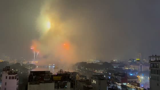 Fireworks light up Hoàn Kiếm Lake at midnight in Hanoi, Vietnam